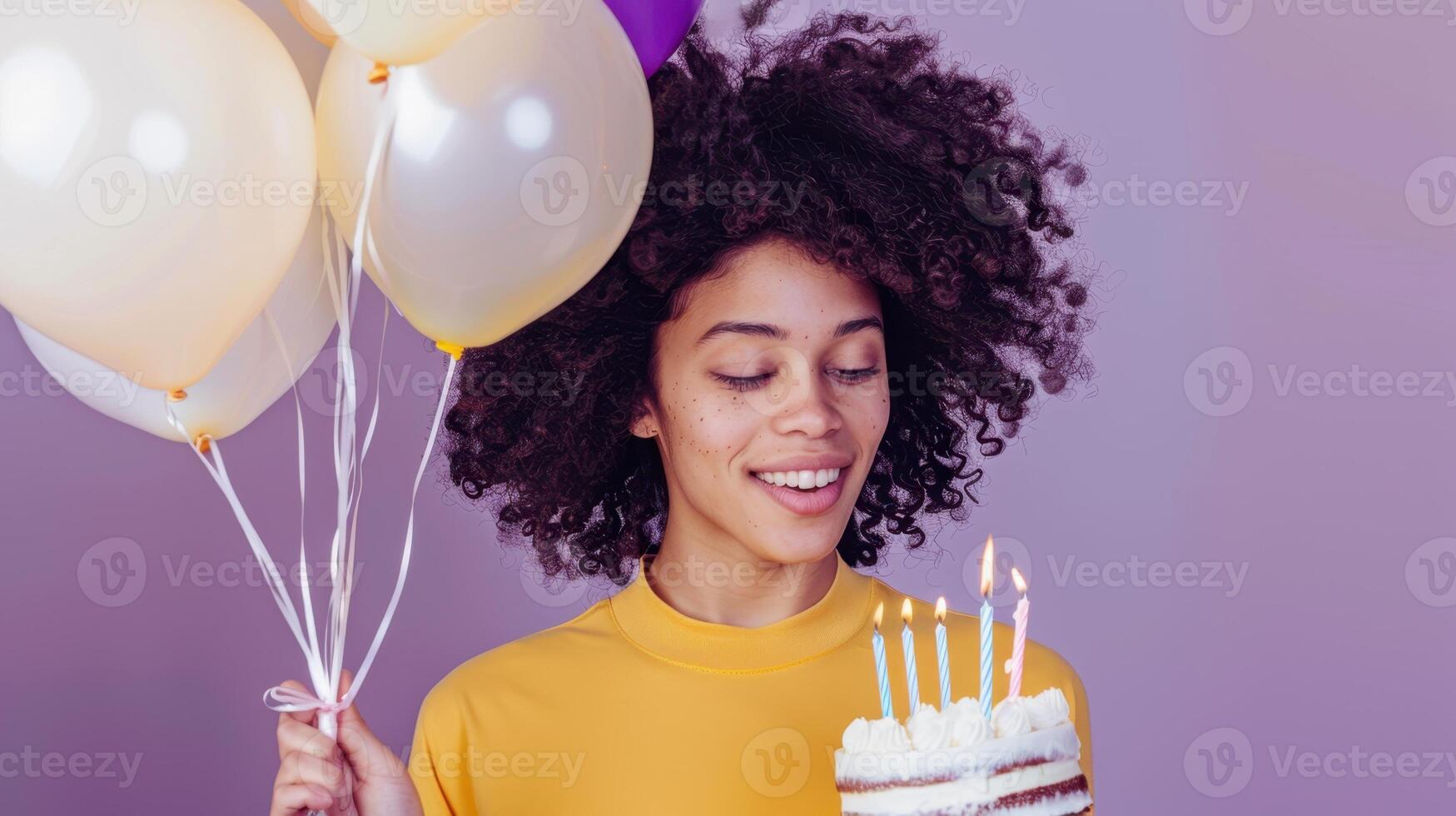 A woman holding a birthday cake with balloons photo