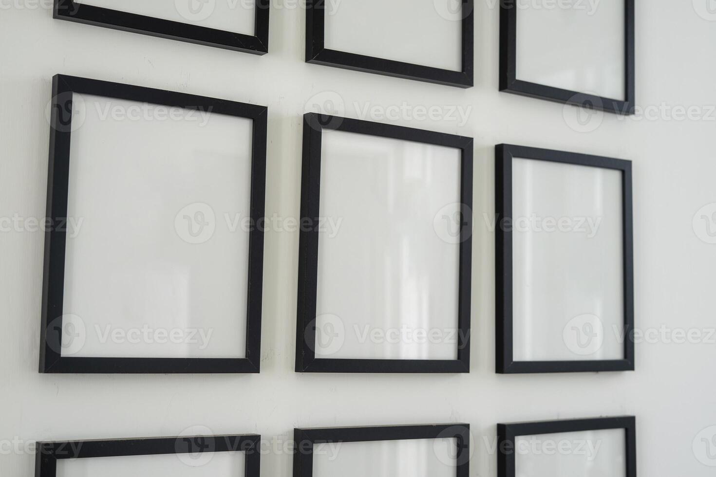 Blank frame for photo mockup hanging on the wall