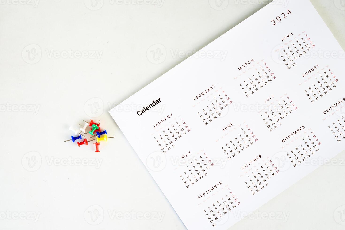 calendar with stack of colorful pin on the table photo