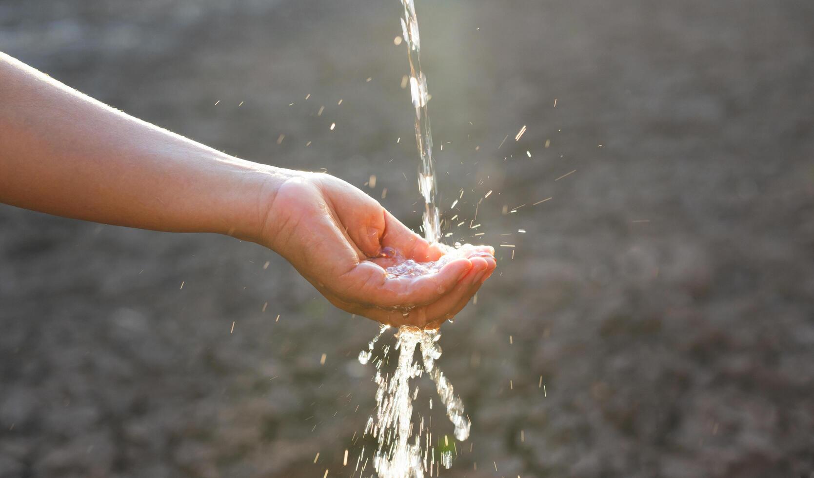 hand is holding stream of water photo