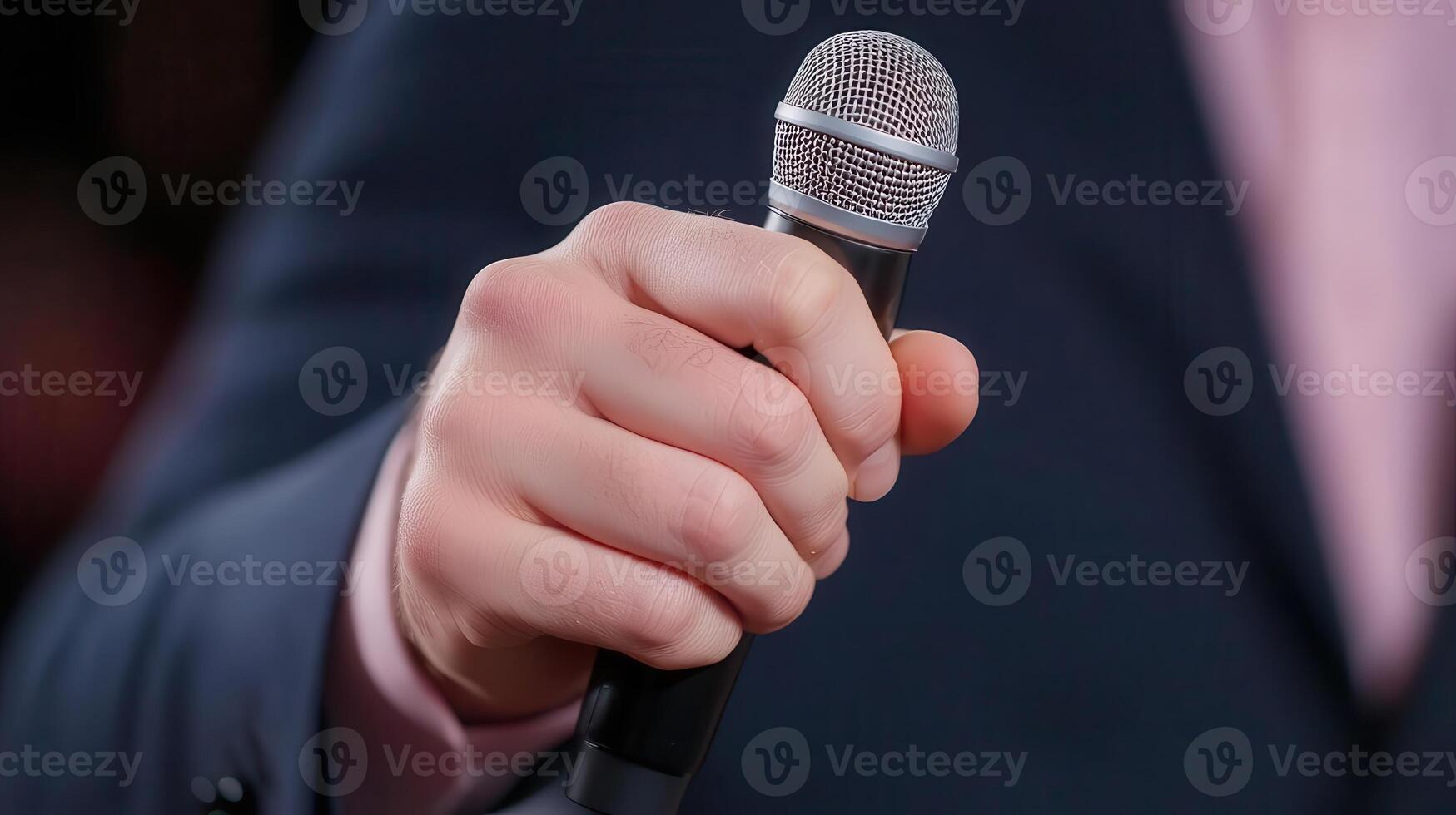 A person holding a microphone in their hand photo