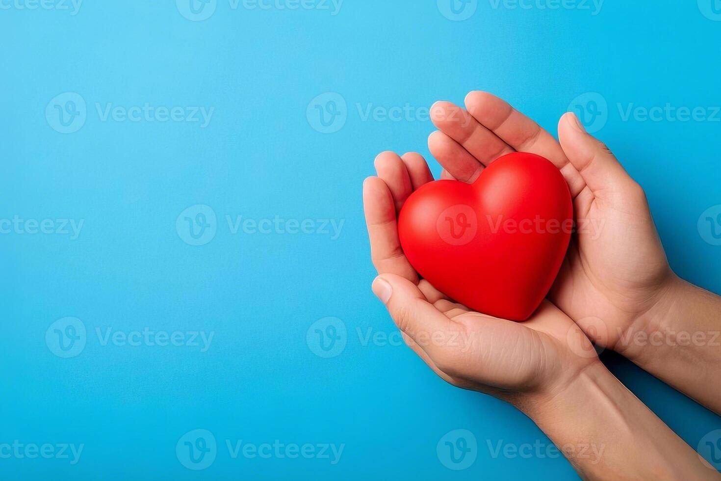 Compassionate Gesture Hands Holding A Red Heart On A Soft Blue Background photo