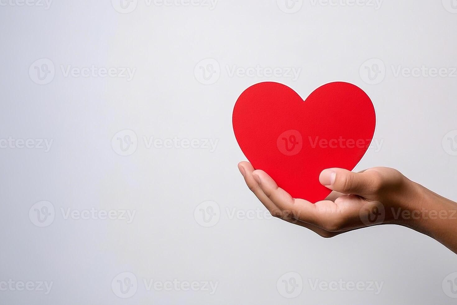 Hand Gently Holding A Red Heart Token Of Affection photo