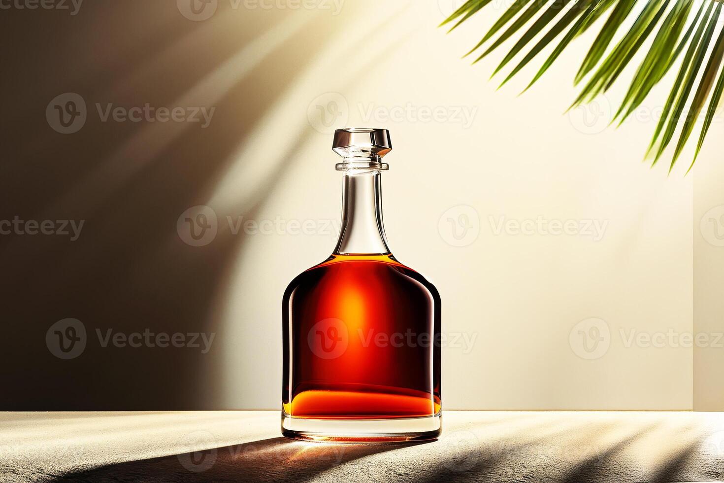 A bottle of cognac sitting on a table with a palm tree in the background photo