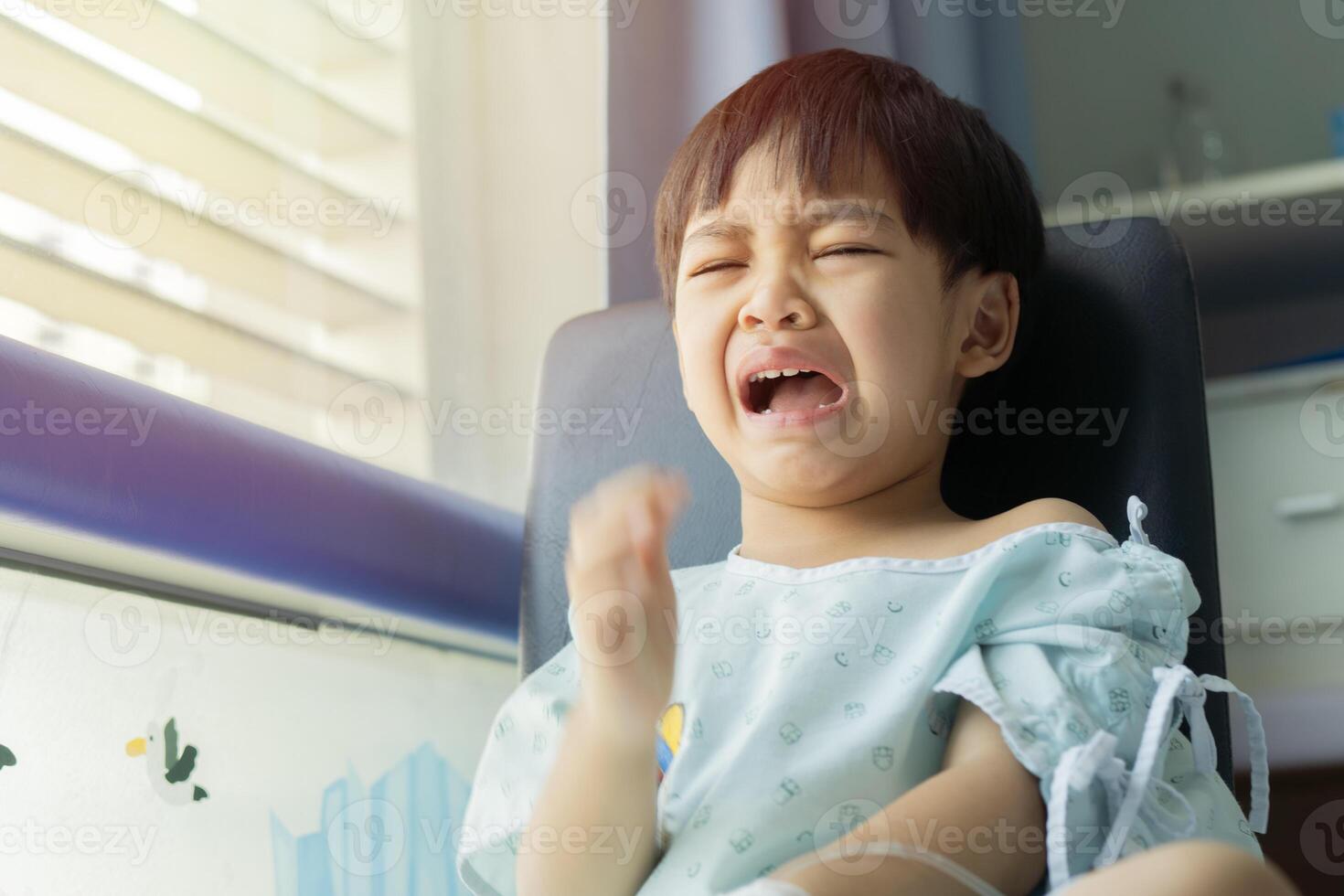 Angry little boys with sad expressions, screaming and crying because he is sick photo