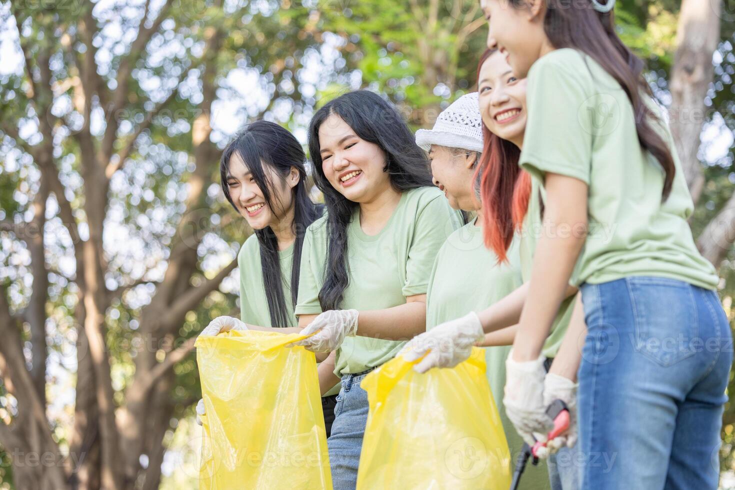 Cheerful Group of Volunteers Engaged in Cleanup Activity, Eco Volunteers Collecting Plastic Waste in Park, Teamwork for a Greener Planet, Female Volunteers Picking Up Trash photo