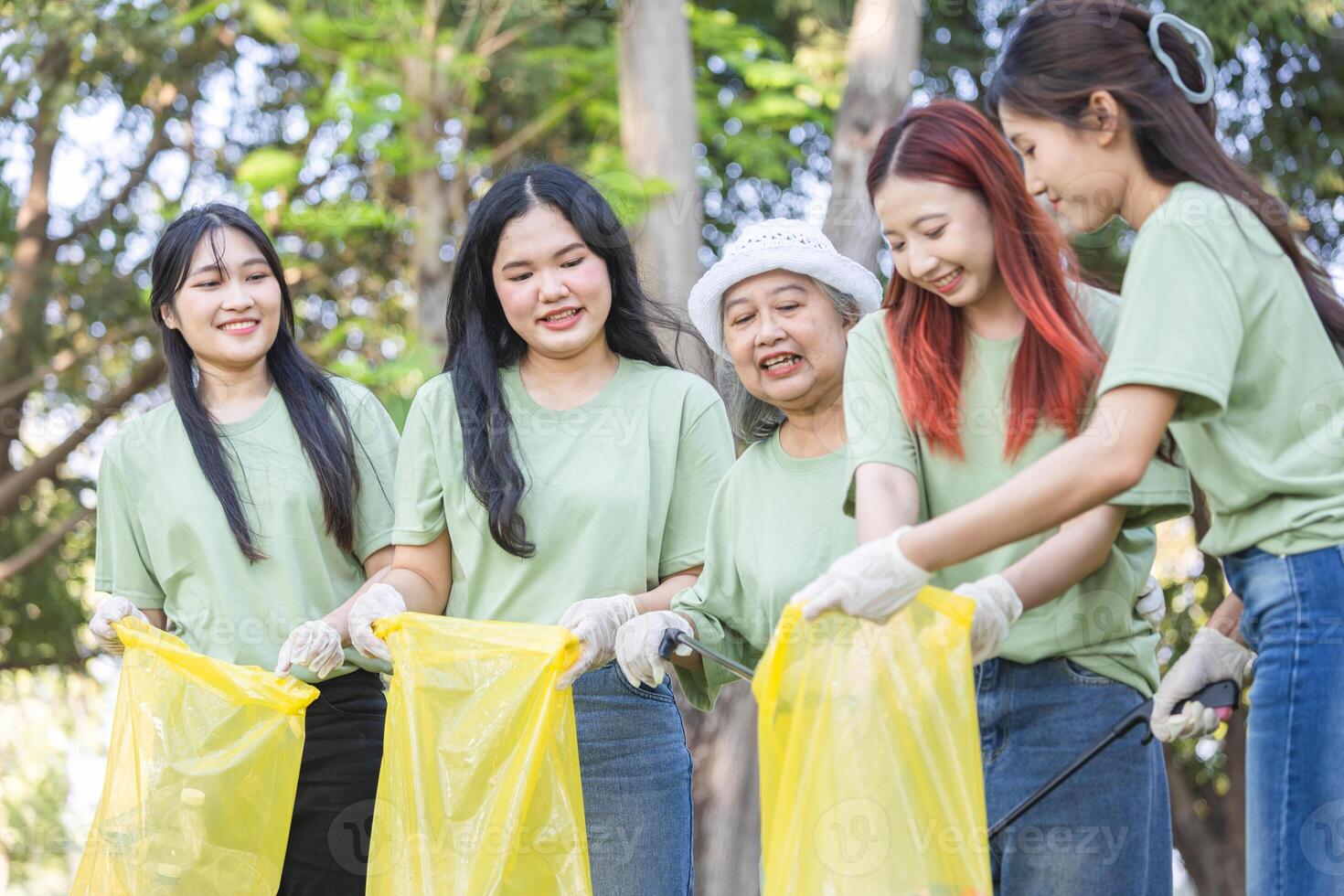 Group of Volunteers Engaged in Cleanup Activity, Eco Volunteers Collecting Plastic Waste in Park, Teamwork for a Greener Planet, Female Volunteers Picking Up Trash, Woman Teamwork photo
