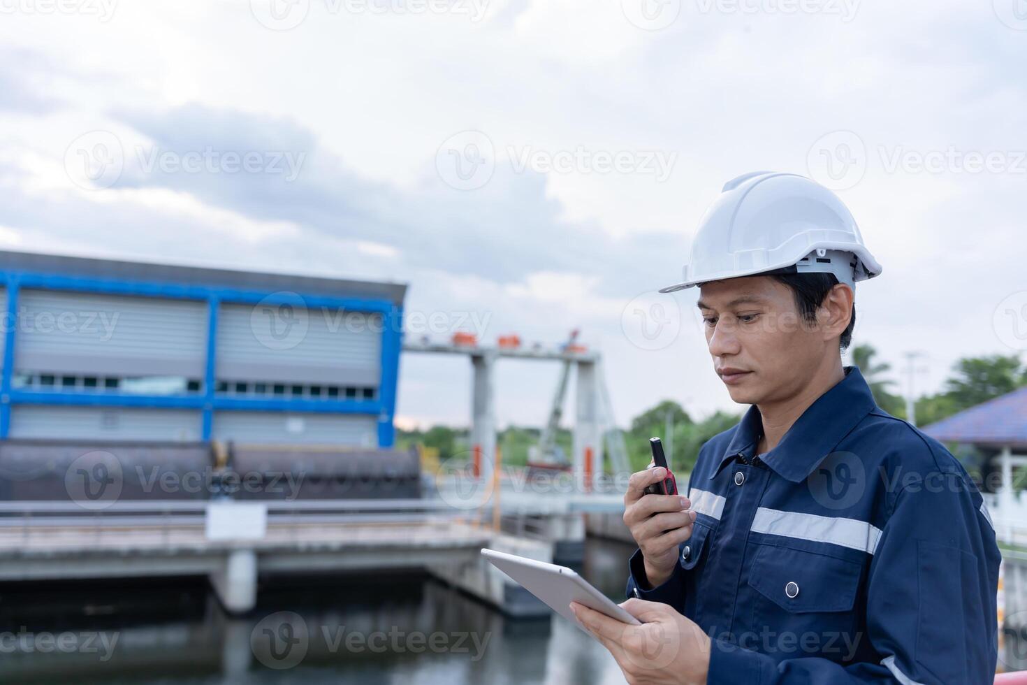 maintenance and inspector Maintenance engineers are using walky talky to inform the results of inspection of buildings and structures. Irrigation engineers are exploring sluice systems photo