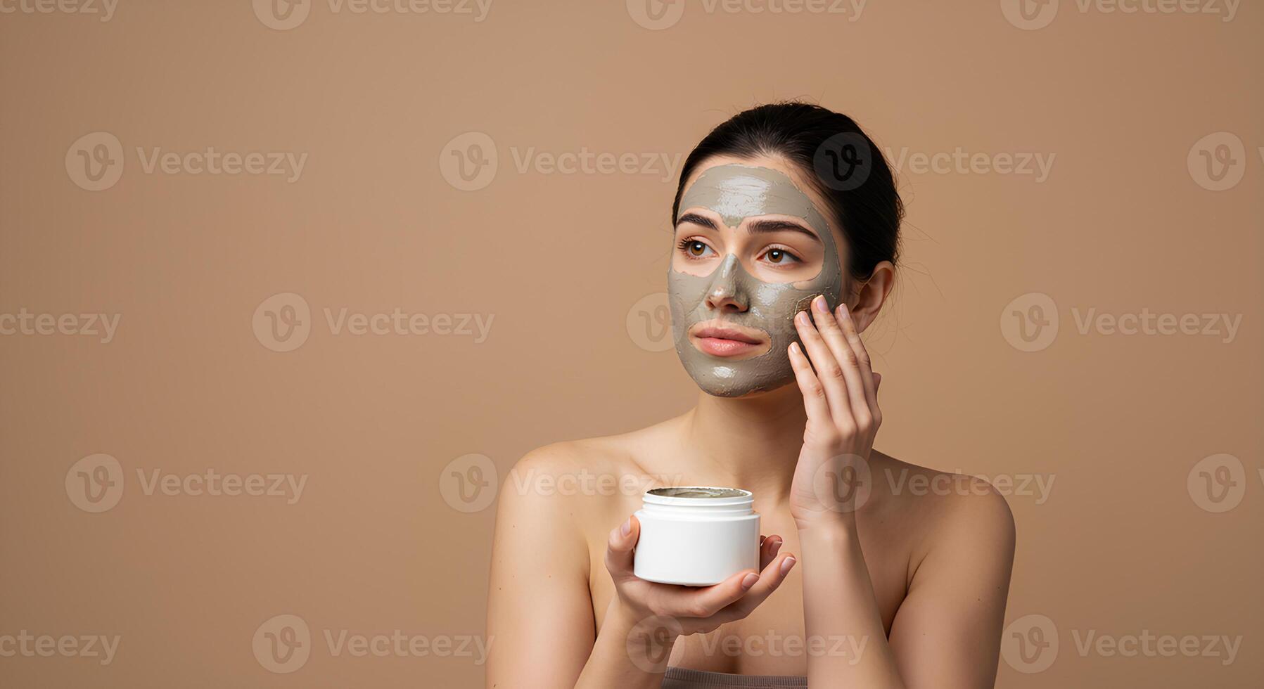 Skincare routine with a woman applying an unbranded facial clay mask to remove impurities and balance her skin barrier for a fresh, matte finish photo