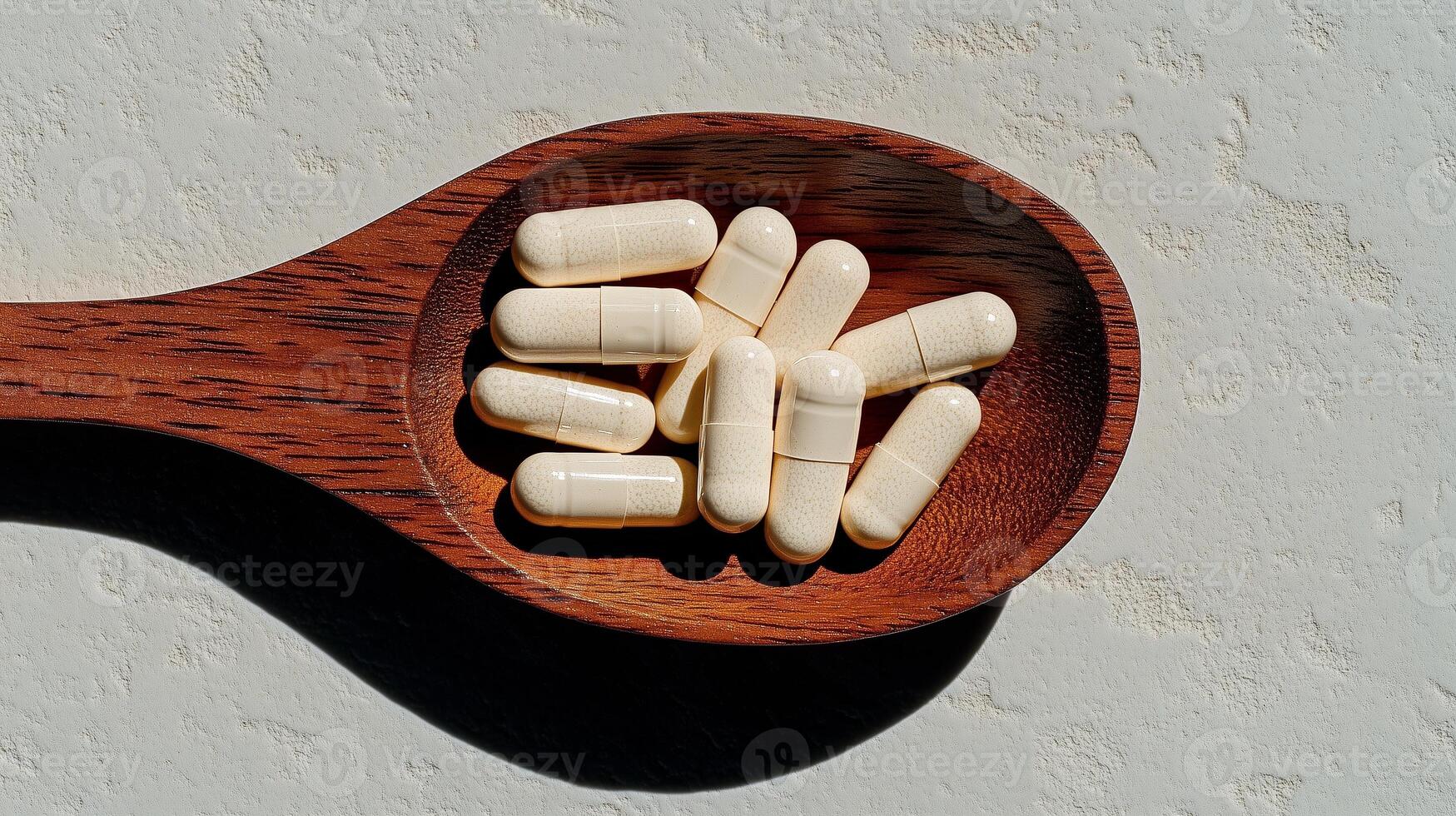 Vitamin capsules scattered on a wooden spoon. 4 photo