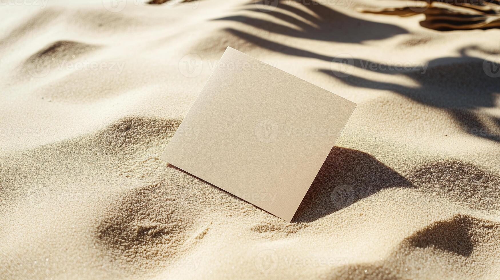 A blank square card on the sand, with shadows and ripples of sunlight. 9 photo
