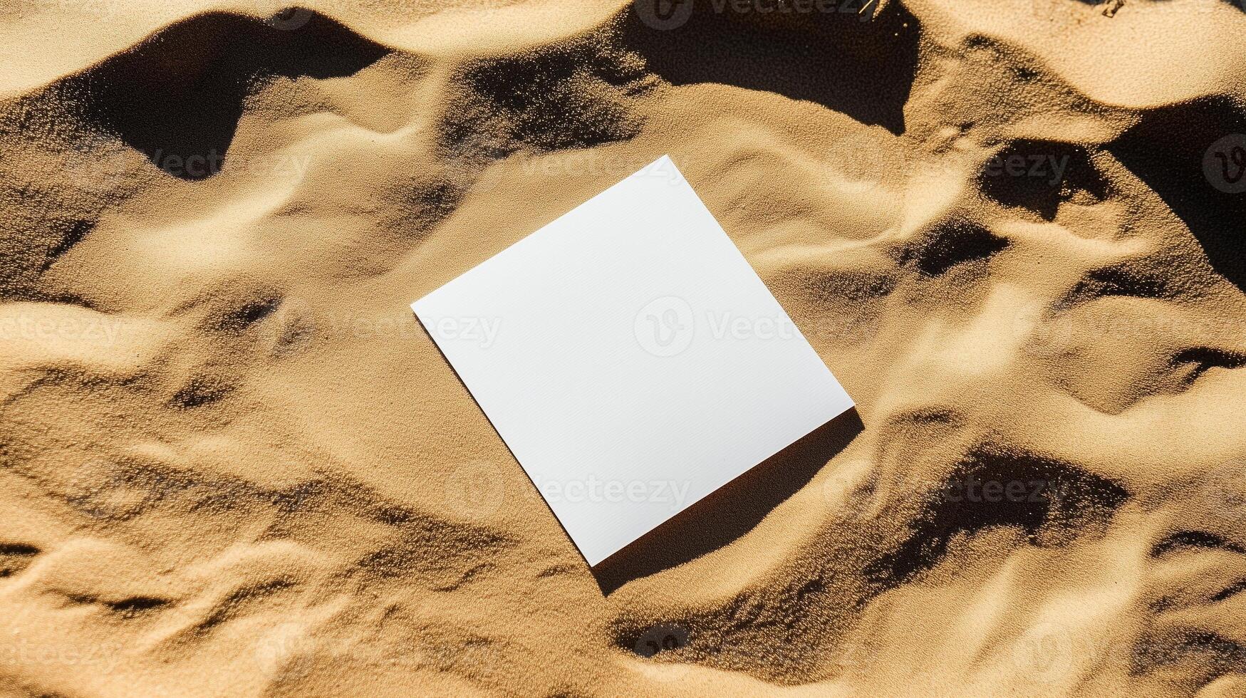 A blank square card on the sand, with shadows and ripples of sunlight. 8 photo