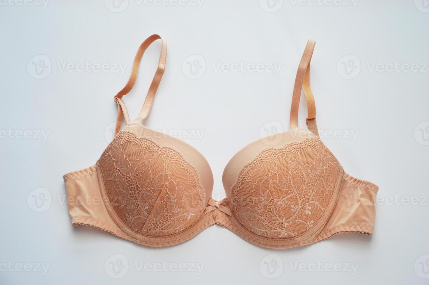 Lingerie. Elegant beige bra on a white background. Beautiful lace women's underwear. photo