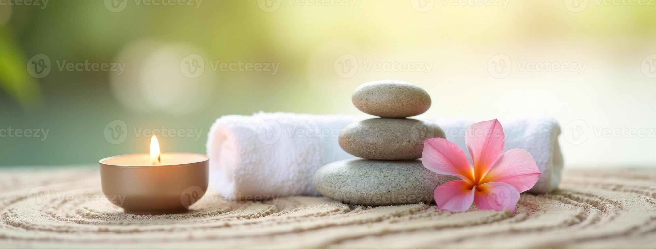 Spa stones and a candle on a wooden table photo