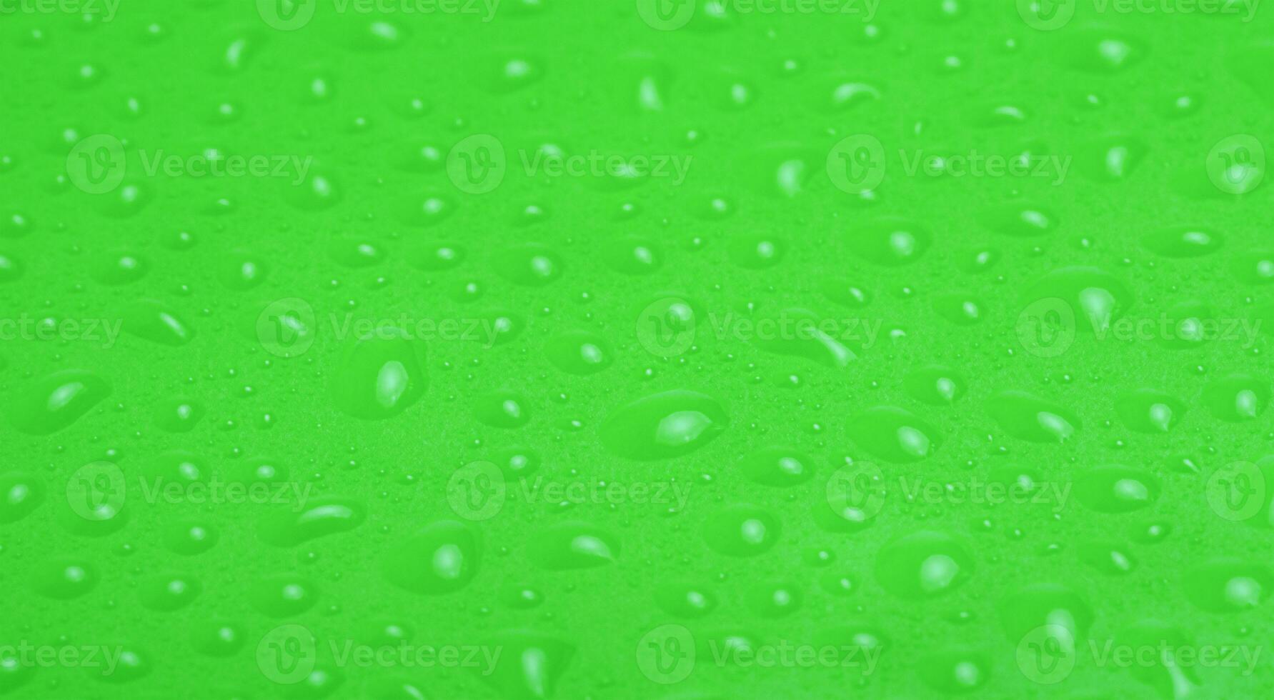 Green plastic with water drops macro photo. Abstract background. photo