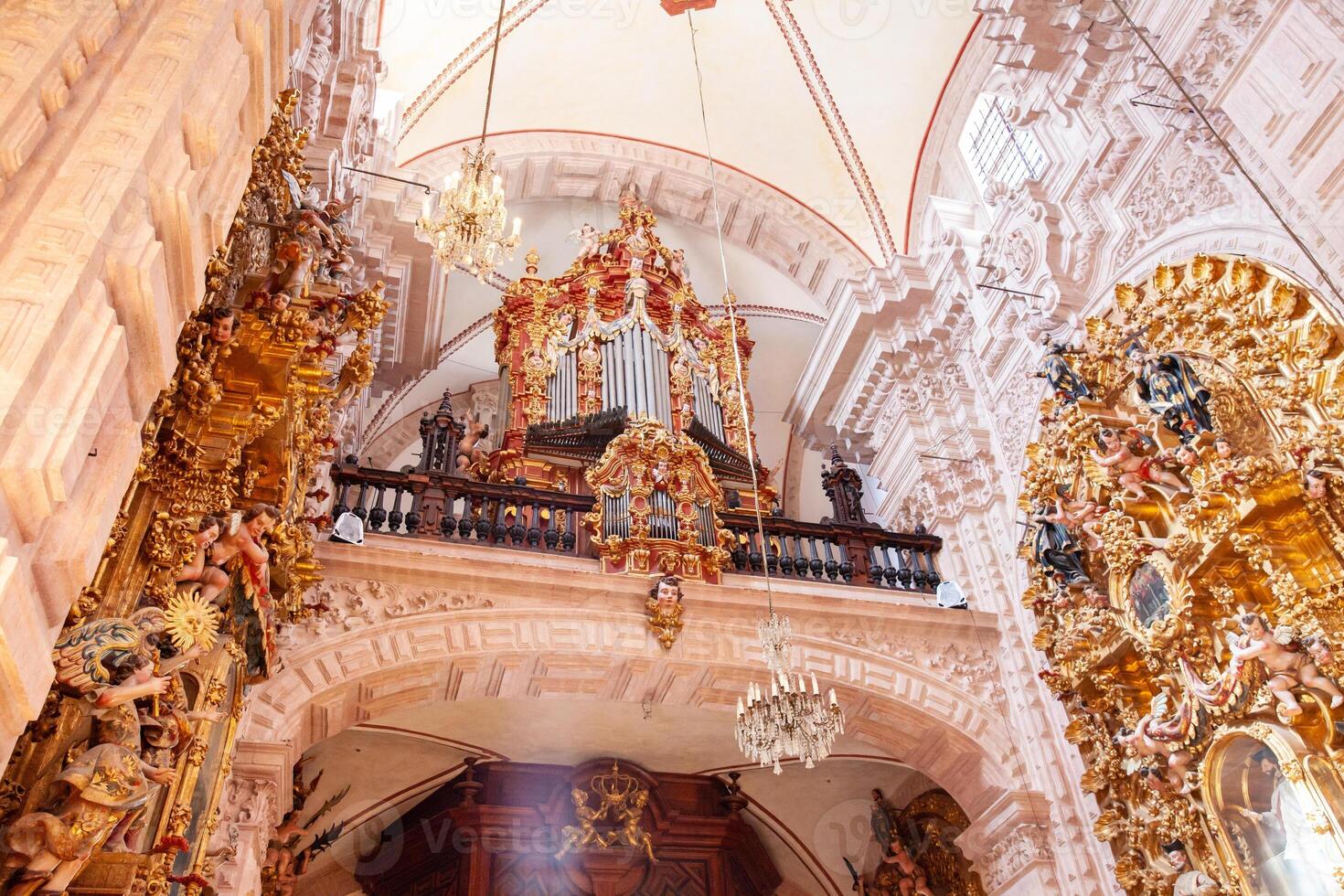 The beautiful choir organ, built in 1760, located above the main entrance of the Santa Prisca church of Taxco de Alarcon. photo
