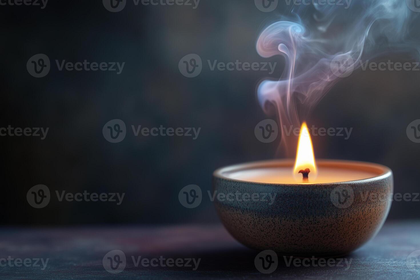 Luxurious soy wax candle burning softly in a serene setting with gentle smoke rising photo