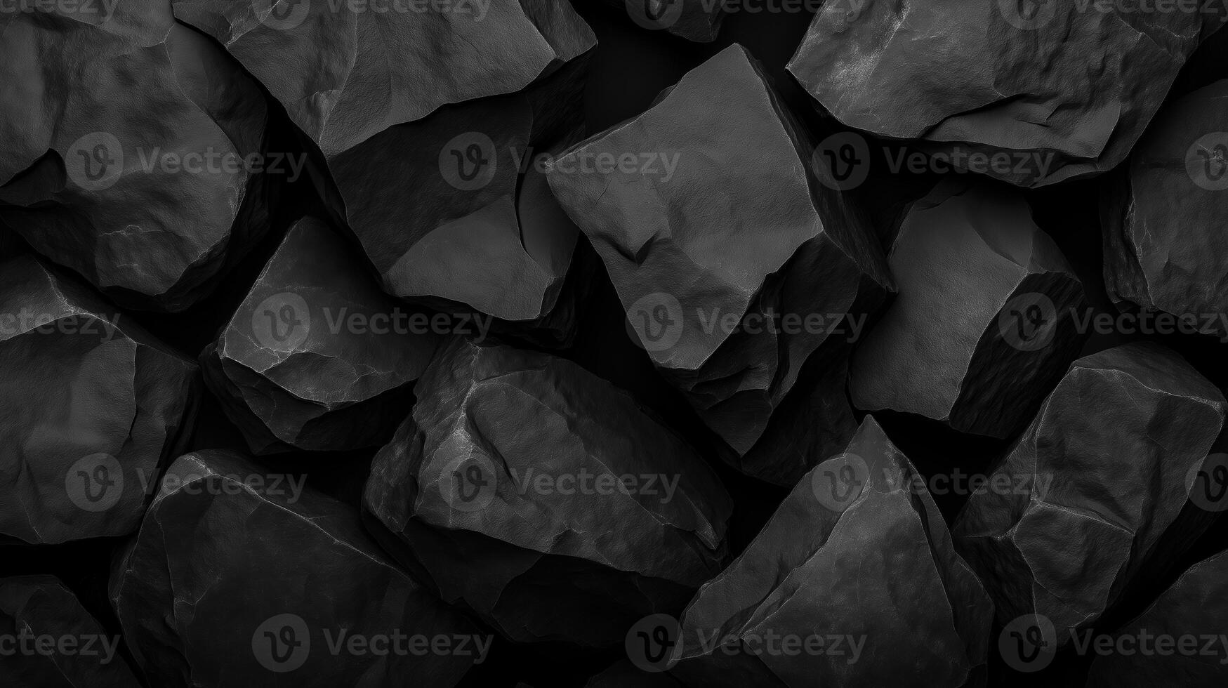 Dark black rock texture with rugged stone surfaces creating a natural and abstract background pattern photo