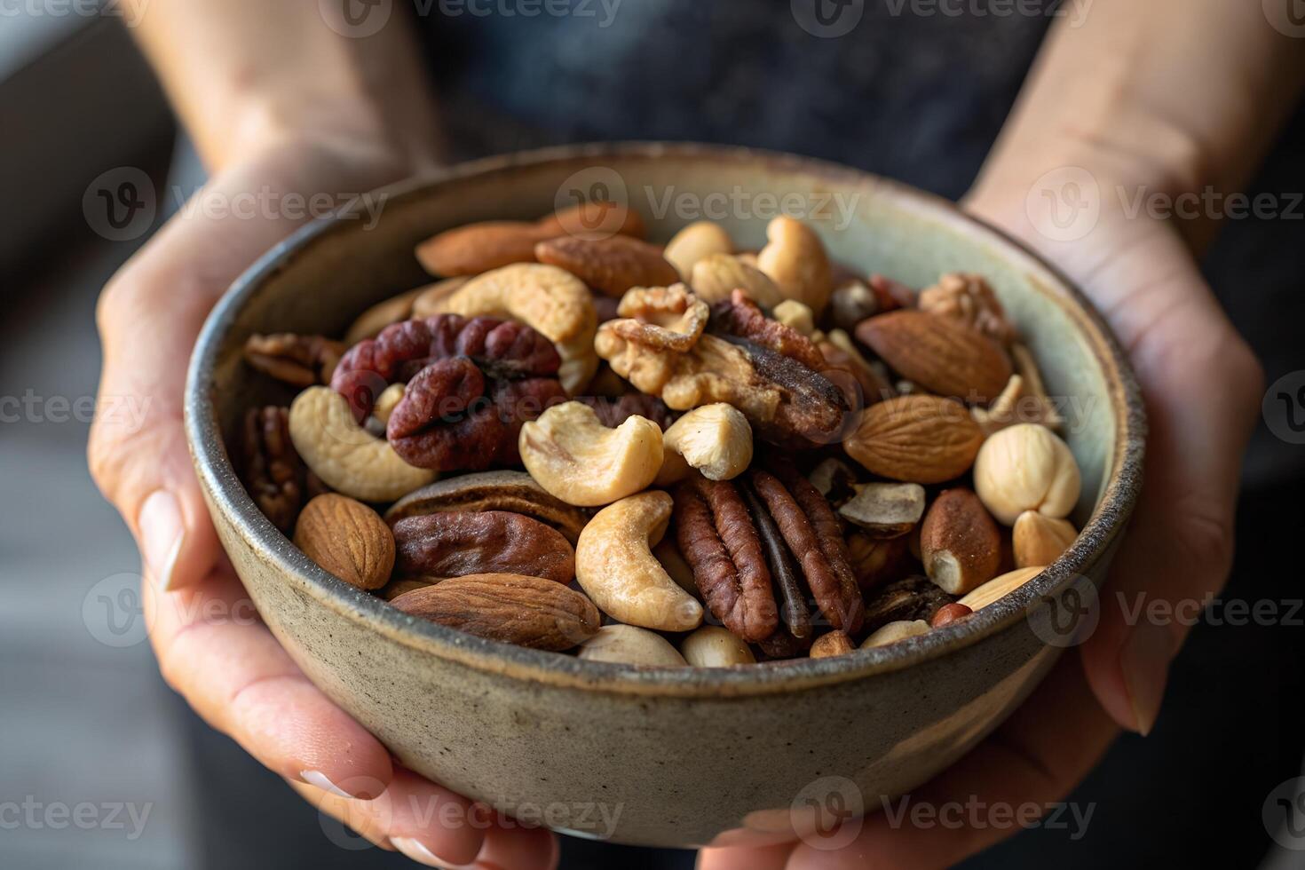 Assorted Mixed Nuts in a Bowl Held by Hands photo