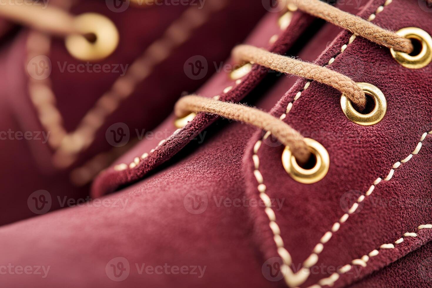 Close-up of dark cherry suede boots with gold accents, capturing a retro glamour style and chic nostalgia photo