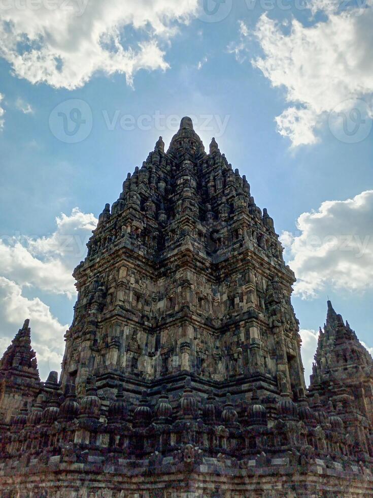 Prambanan Temple with a blue sky and white clouds in the background. photo