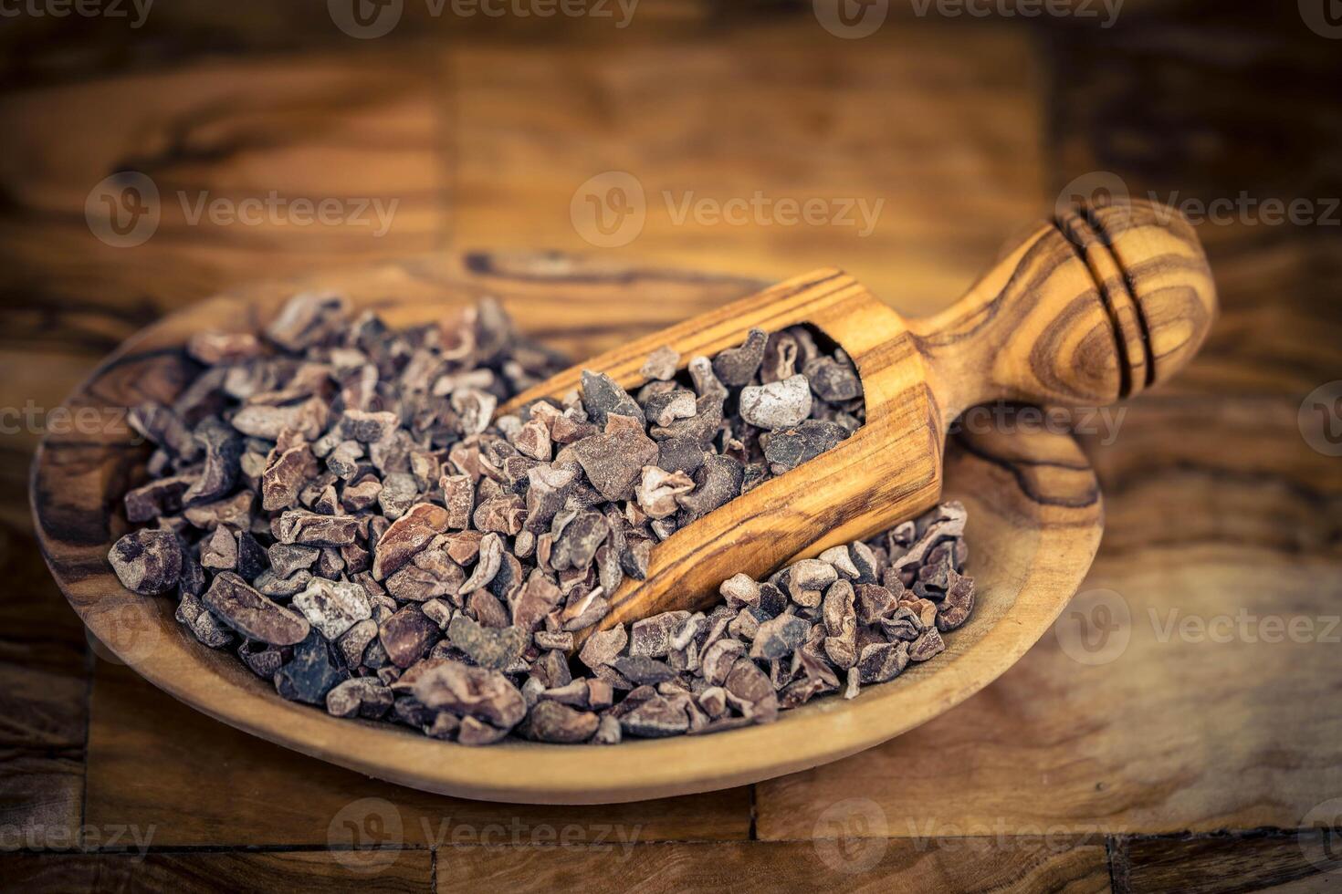 brown chocolate nibs on olivewood photo