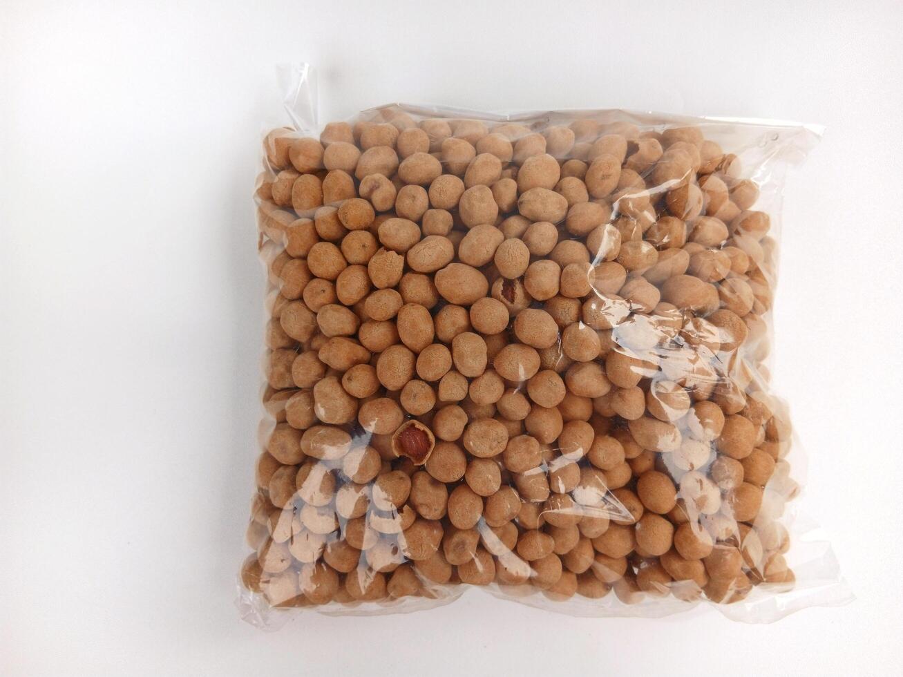 Indonesian traditional snack egg coated peanut called kacang telur, It is made with peanuts mixed with egg batter and dusted with flour, plus a few seasoning ingredients, and then deep fried. photo