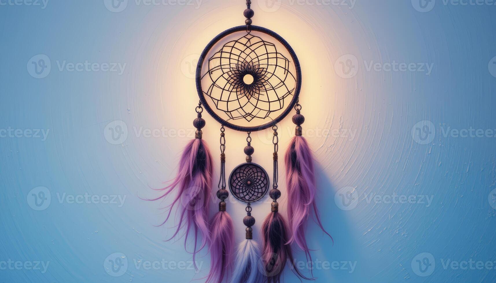 Dreamcatcher adorned with pink and purple feathers hanging against a blue wall, symbolizing protection and cultural heritage, often used for decorative purposes. photo