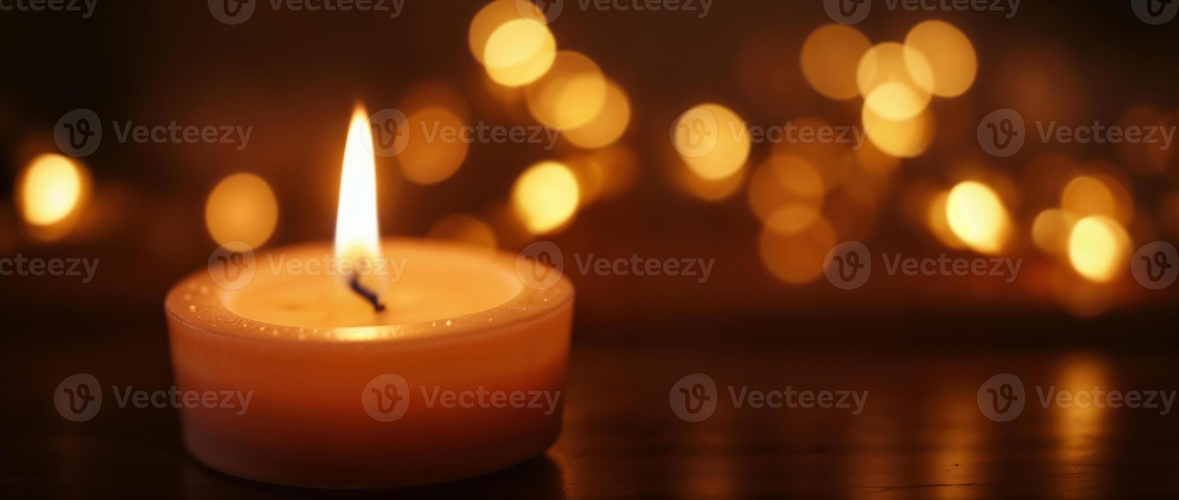 Lit candle with bokeh lights in the background photo
