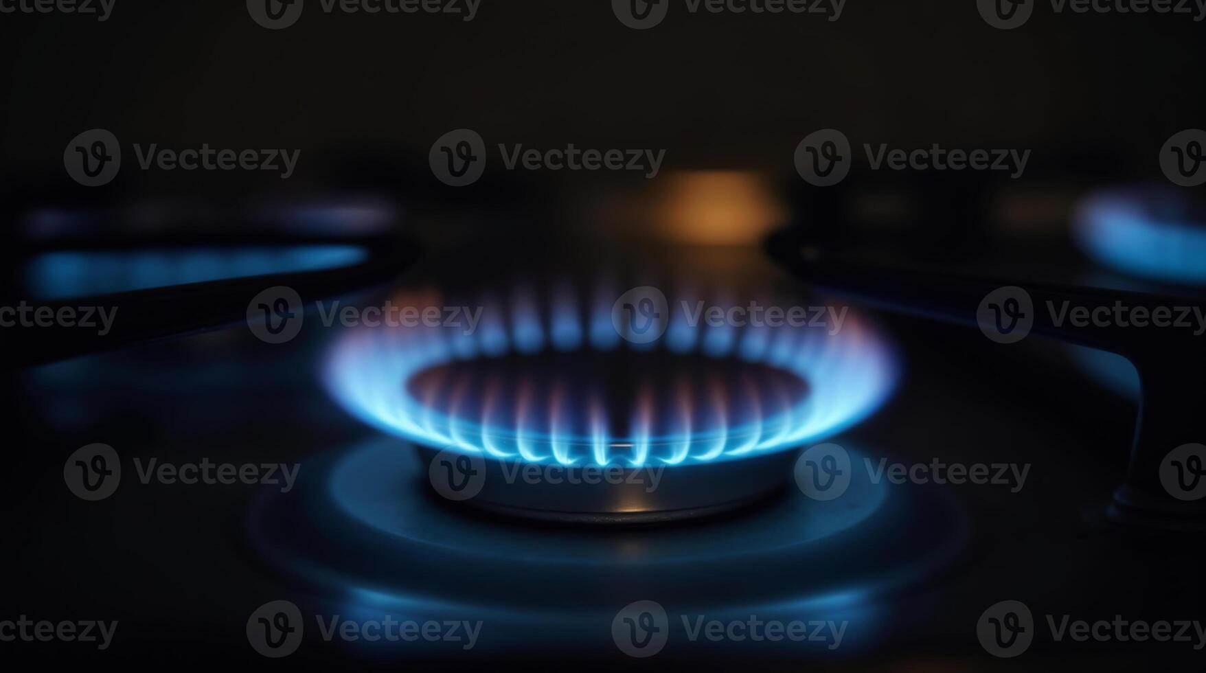 Blue flames on a gas stove burner in the dark photo