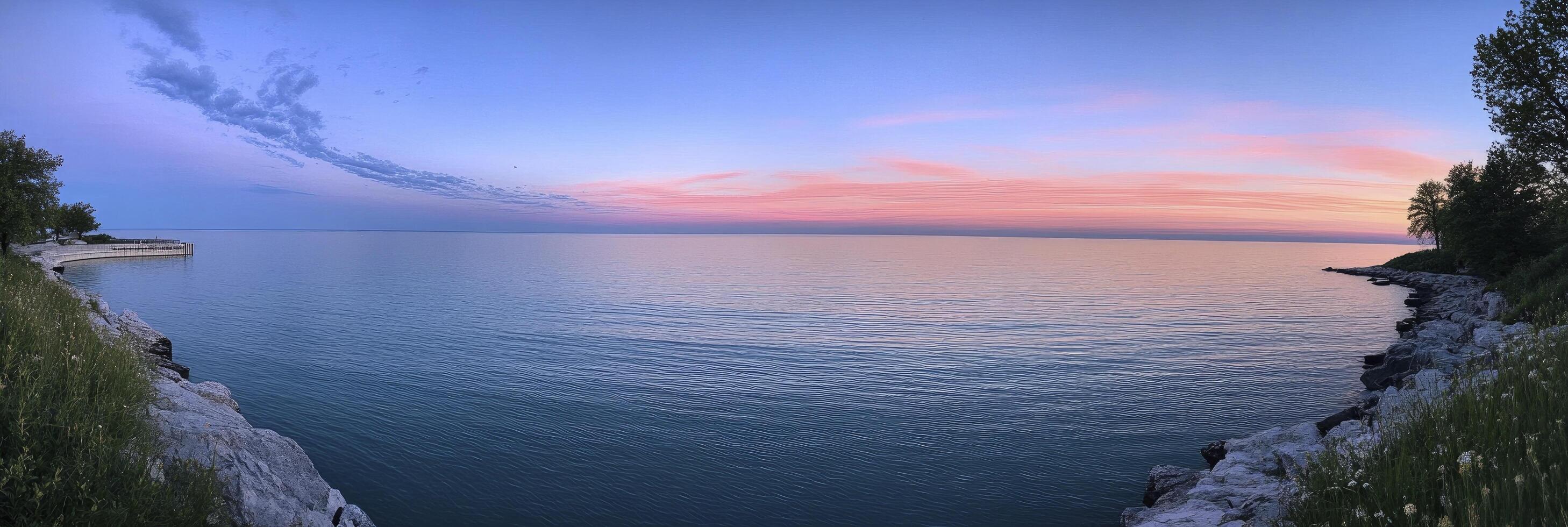 A view of the ocean at sunset from a cliff photo