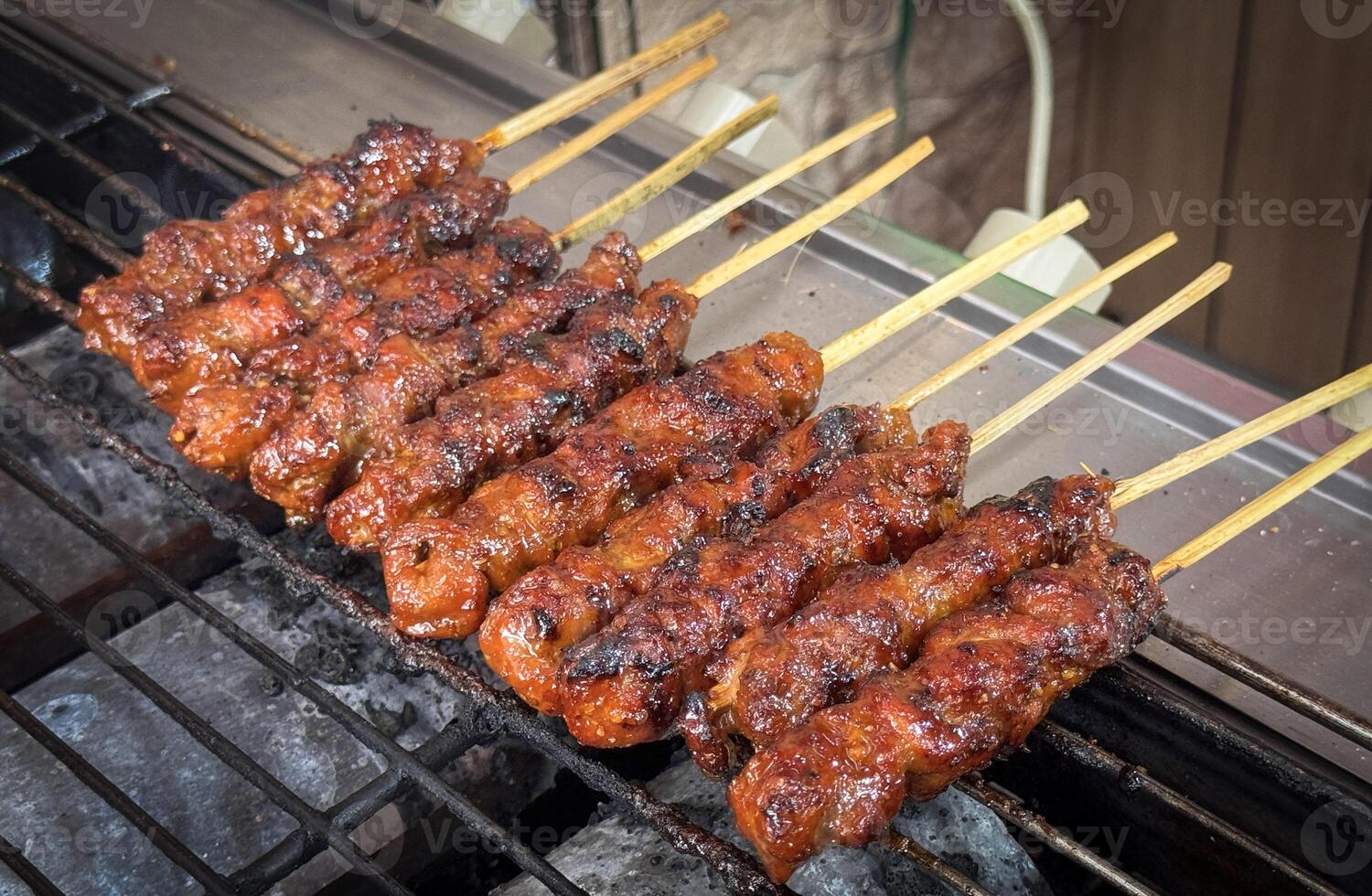 skewered beef meat on a grill, or barbecue bbq, locals called it beef satay showcasing their vibrant glaze and texture photo