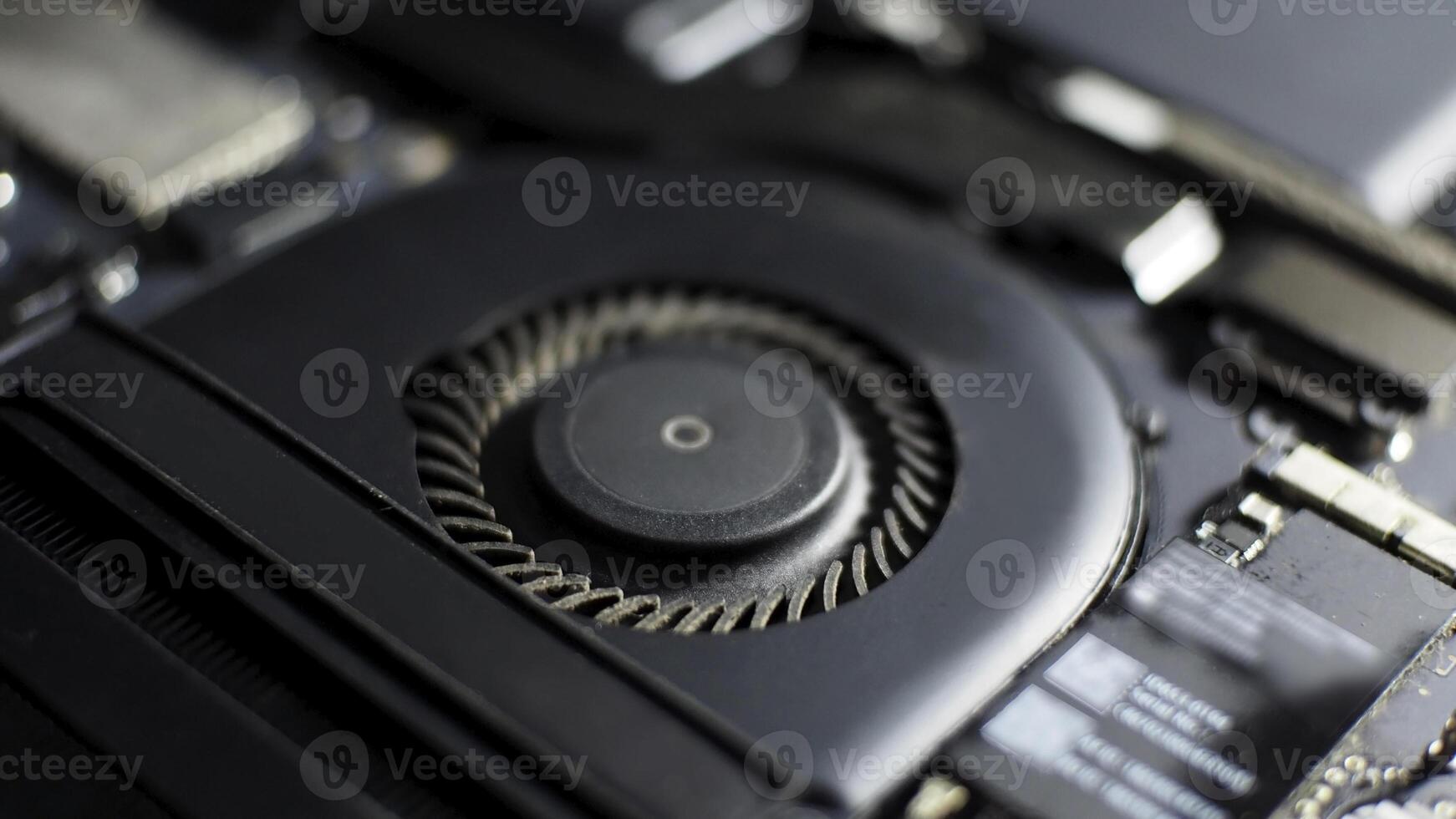 a close up of a notebook motherboard with a fan photo