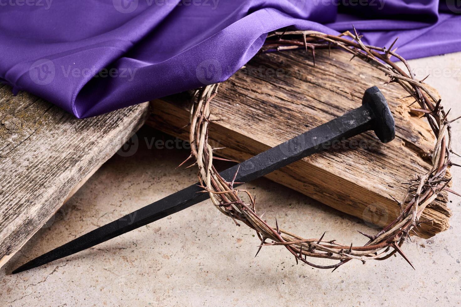 Easter background depicting the crucifixion with a rustic wooden cross, crown of thorns and nails. photo
