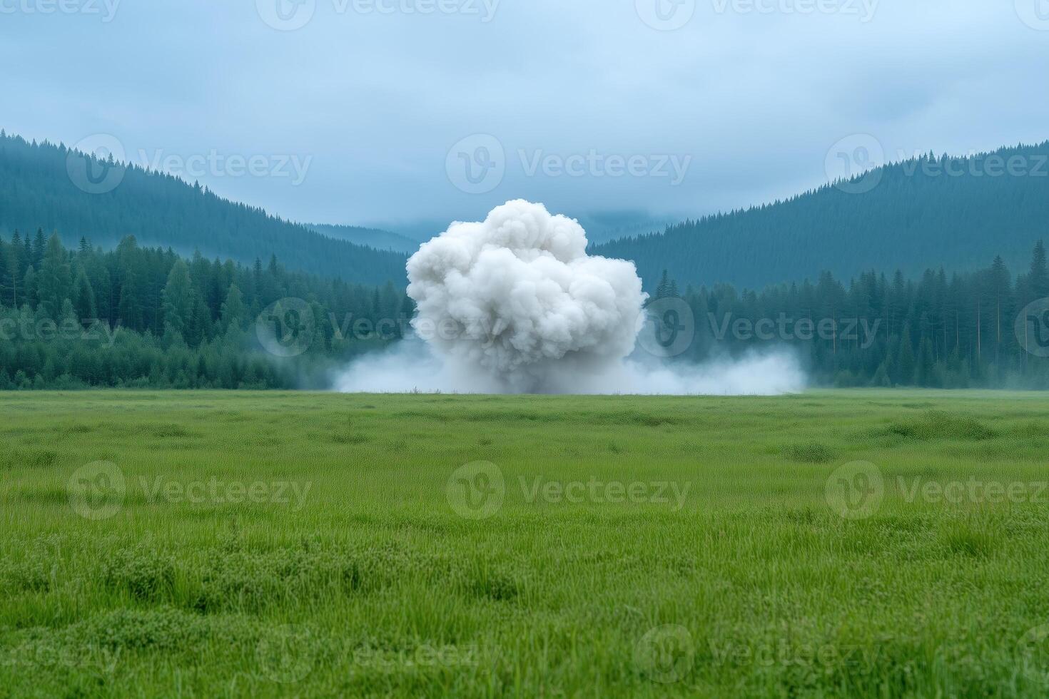 large explosion in the middle of a meadow in the mountains. photo