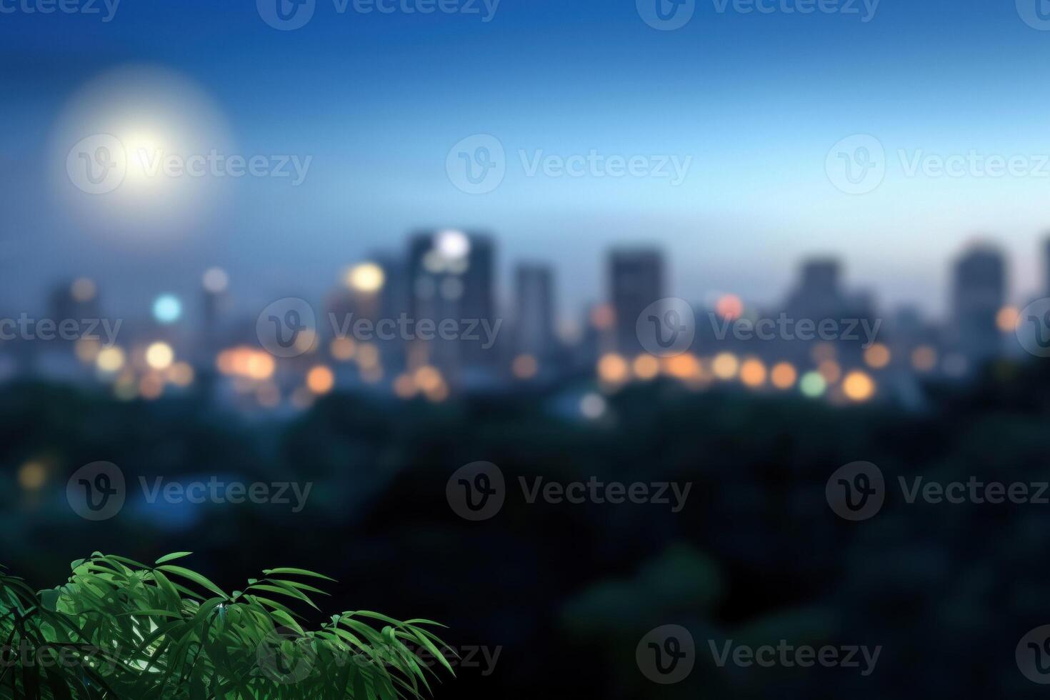 blurred cityscape at night with green leaves on a foreground and full moon photo