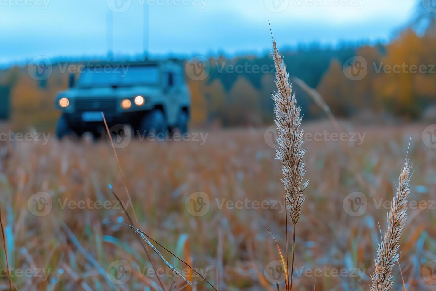 Autumn landscape with the military vehicle on the background of the field photo