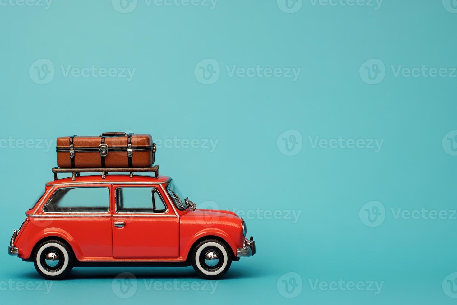 summer vacation travel image little red retro toy car with luggage on light blue background with copy space photo