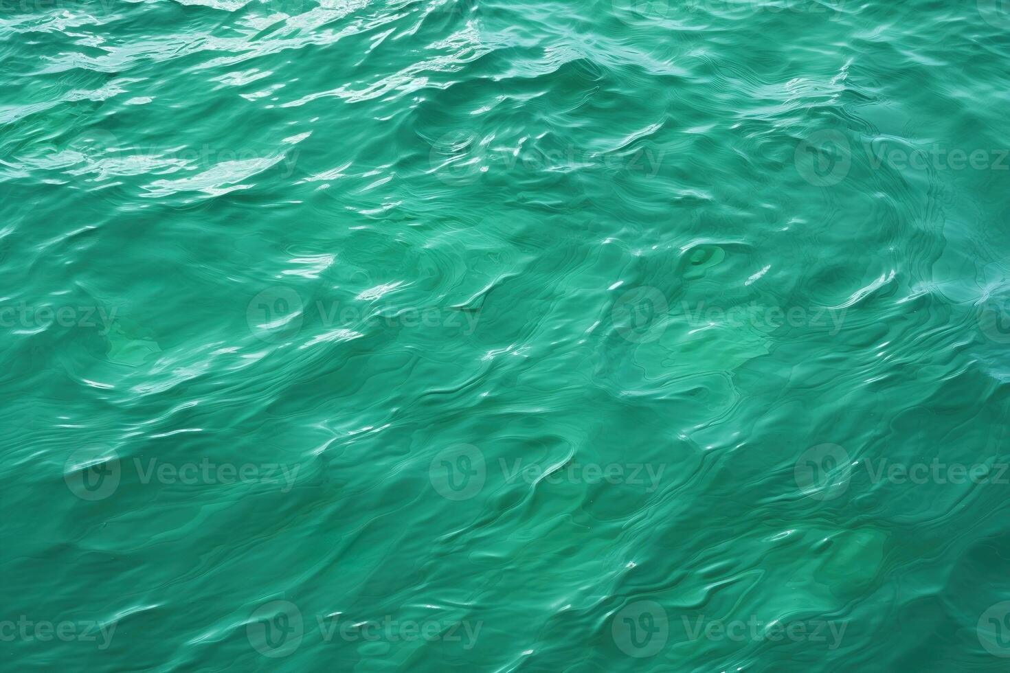 top view abstract background green water surface with light ripples photo