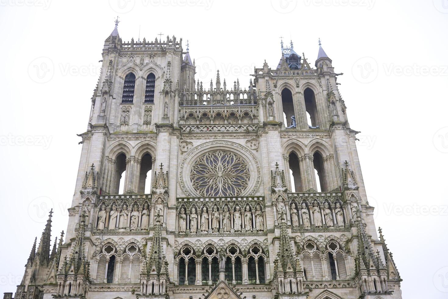 Front view of ornate Gothic cathedral facade in Amiens, France photo