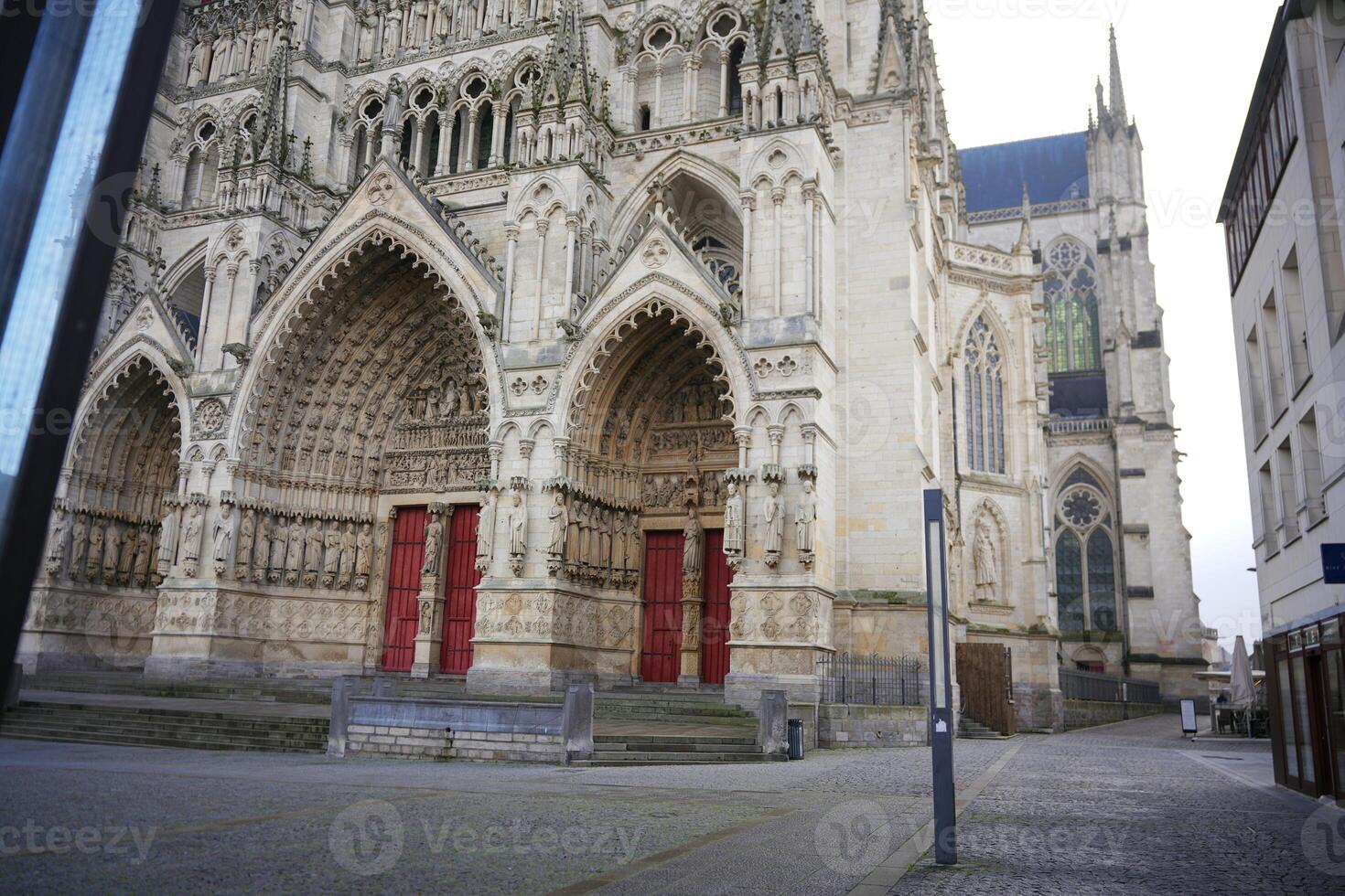 Gothic cathedral exterior with ornate portals. Amiens. France 17.02.2025 photo