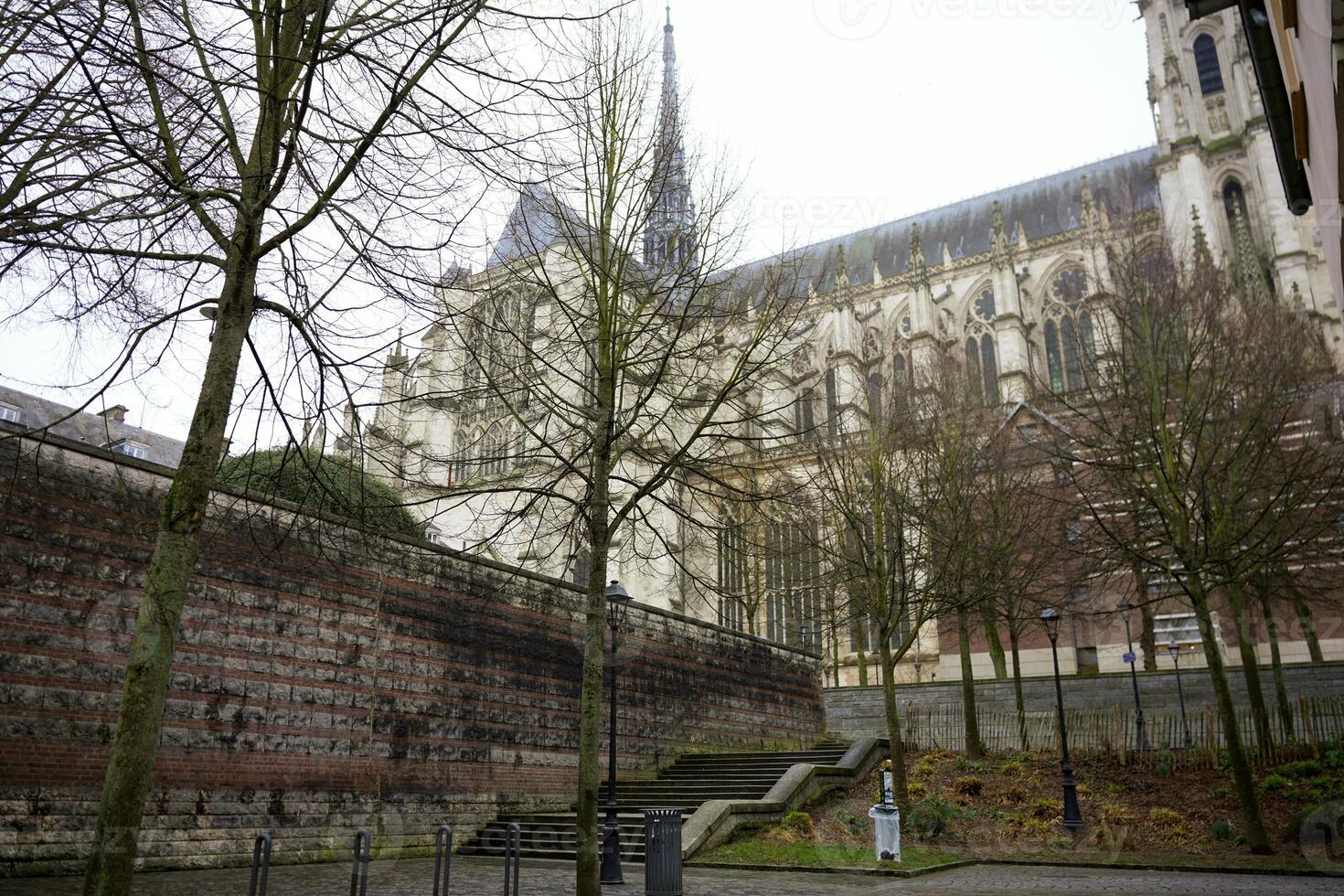 View of Gothic cathedral and stone wall in Amiens, France photo