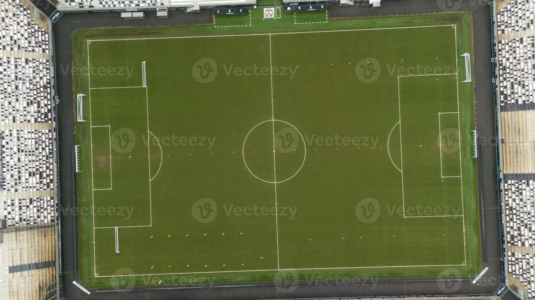 Top-Down Aerial View of Football Field with Marked Lines and Empty Stands photo