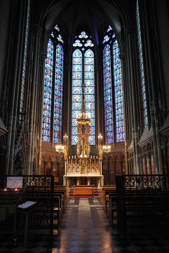 Golden altar with vibrant stained glass in Amiens. France 17.02.2025 photo