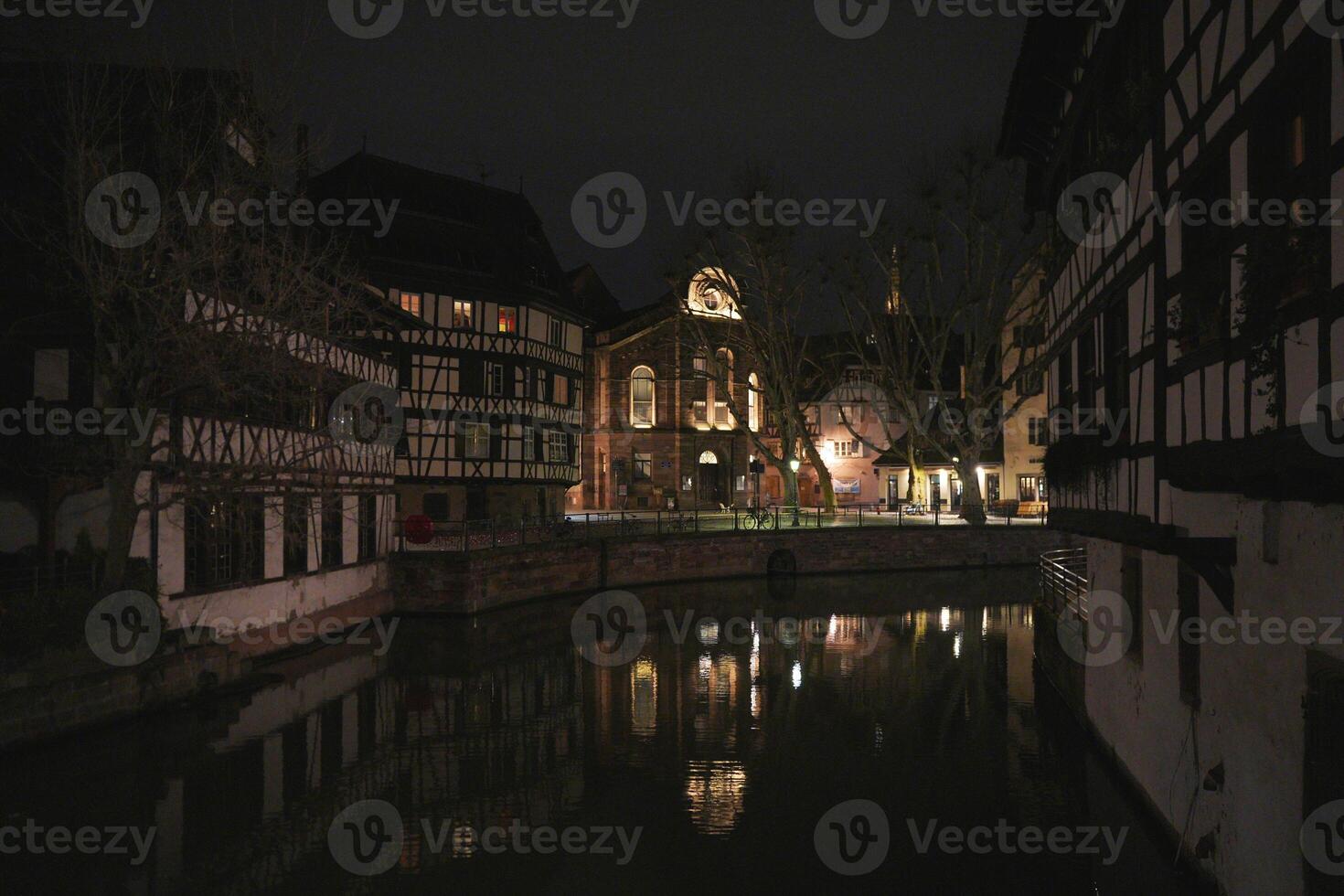 Canal reflections and timbered houses in Strasbourg at night photo