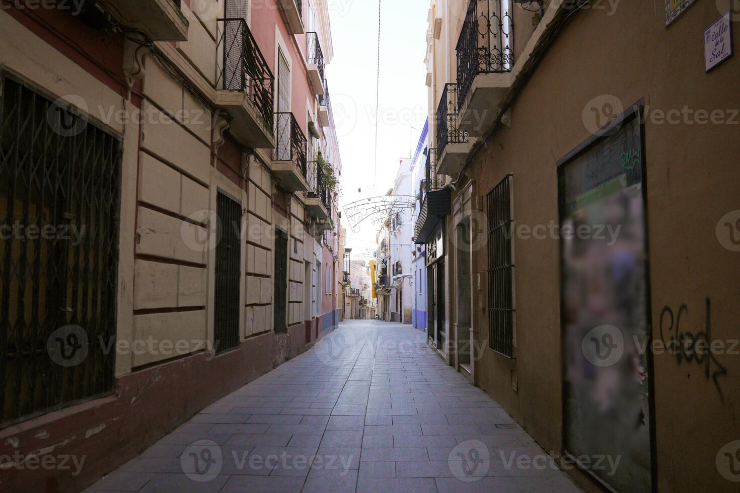 Empty narrow pedestrian street with balconies in Badajoz historic center, Spain photo