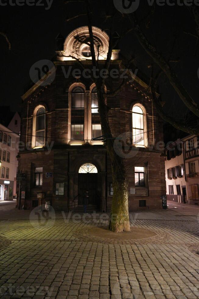 Illuminated historic building at night in Strasbourg photo