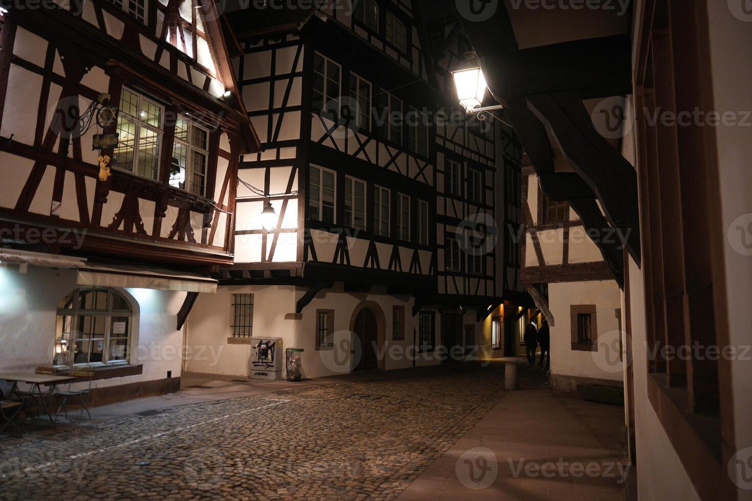 Night alley in Strasbourg with timbered houses photo