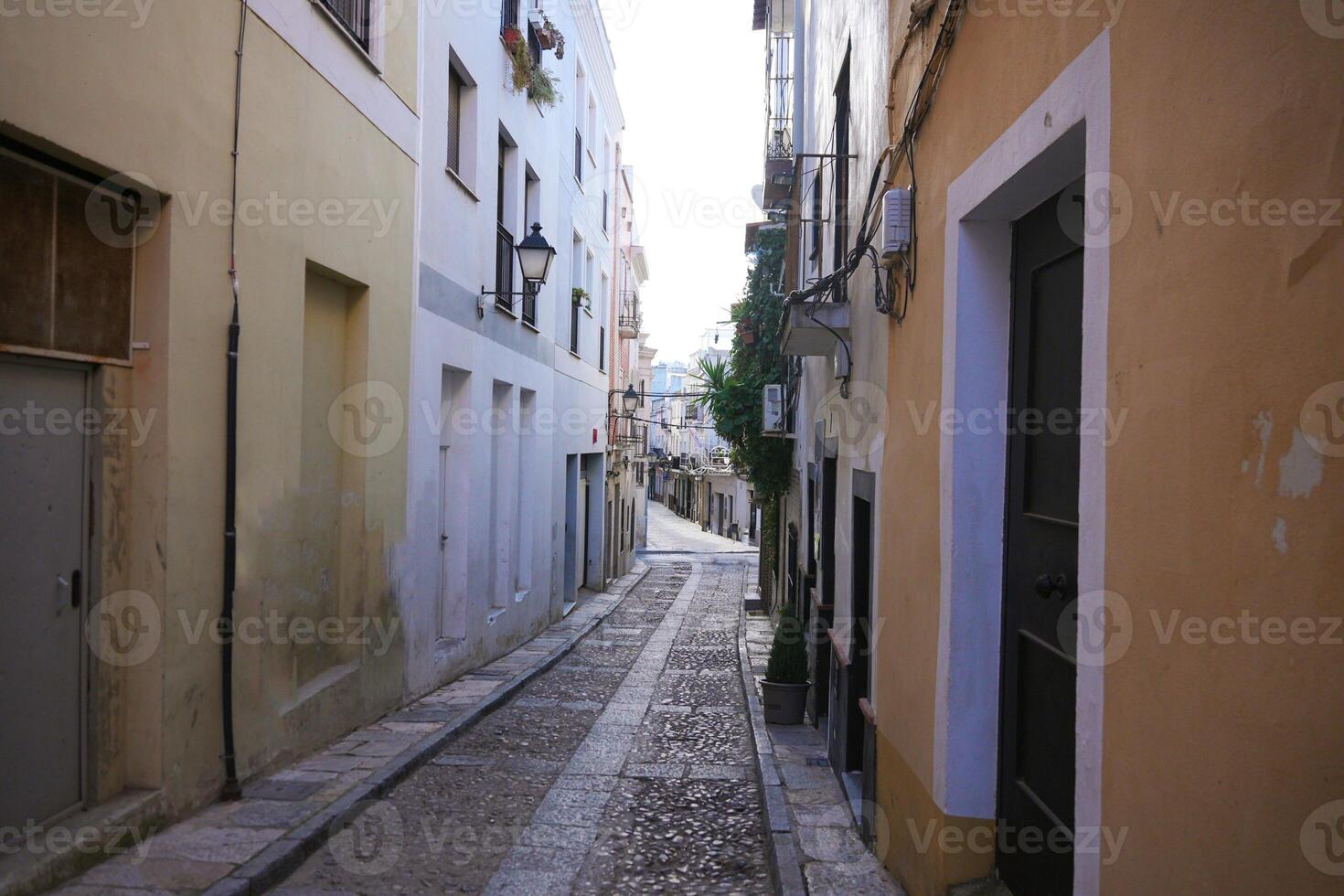 Cobblestone street with colorful buildings in the old town of Badajoz, Spain photo