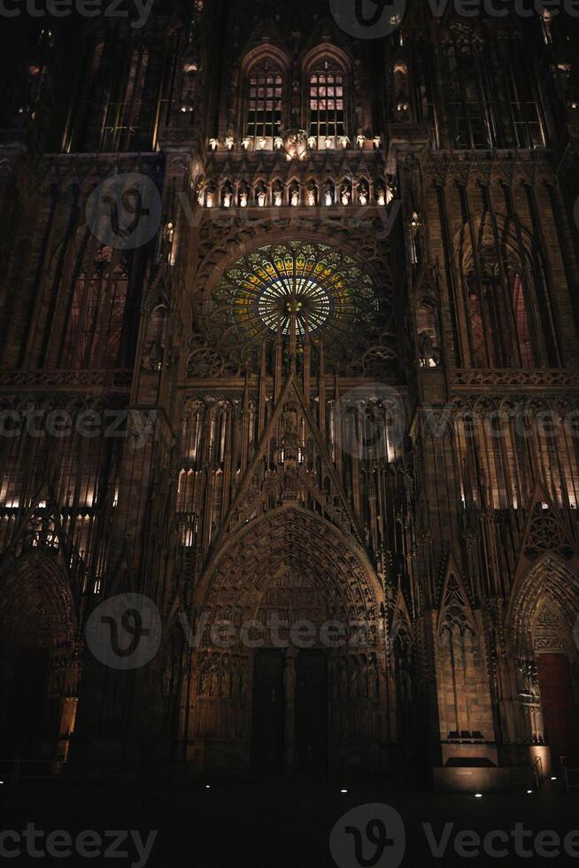 Strasbourg Cathedral entrance and rose window at night photo